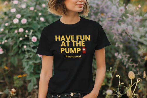 Woman in a garden wearing the black Wattz Good "Have Fun at the Pump" EV graphic tee