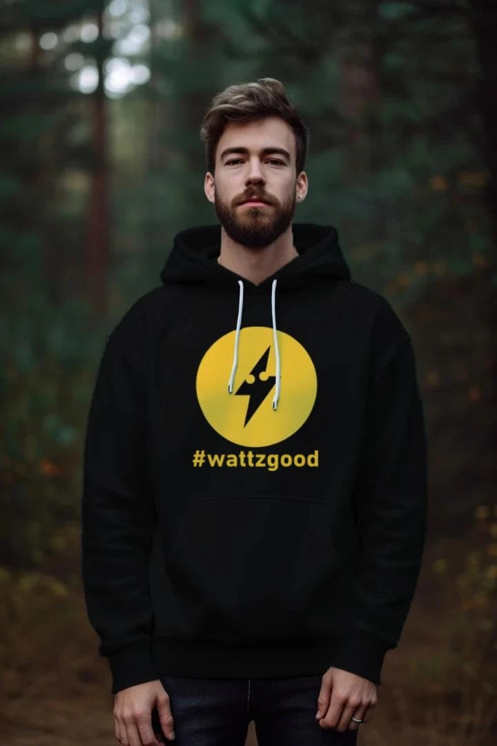 Man wearing the black Wattz Logo Hoodie with the yellow lightning bolt circle and #wattzgood, standing in a forest