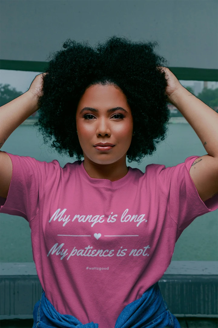 Woman wearing the My Range Is Long women's EV graphic t-shirt, lifestyle photo